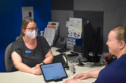 Hearing Australia staff having a discussion with clients