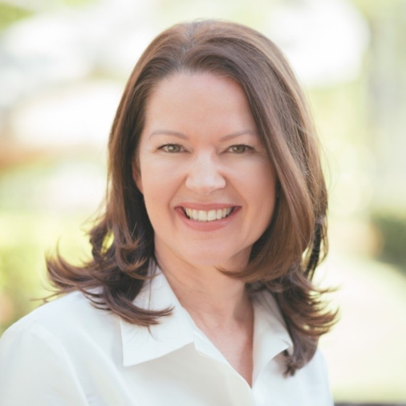 a woman with brown hair smiling