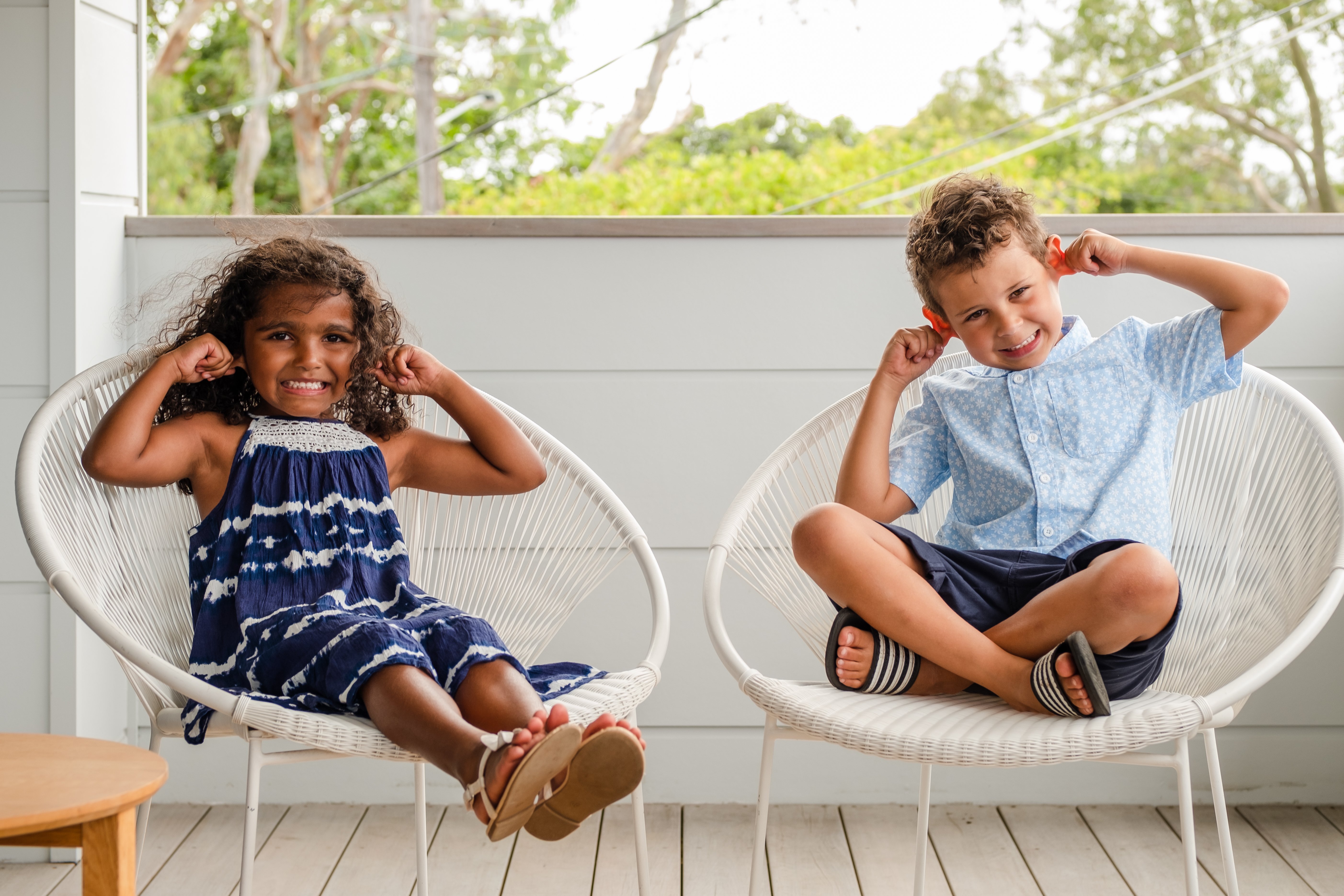 Two children holding their ears.