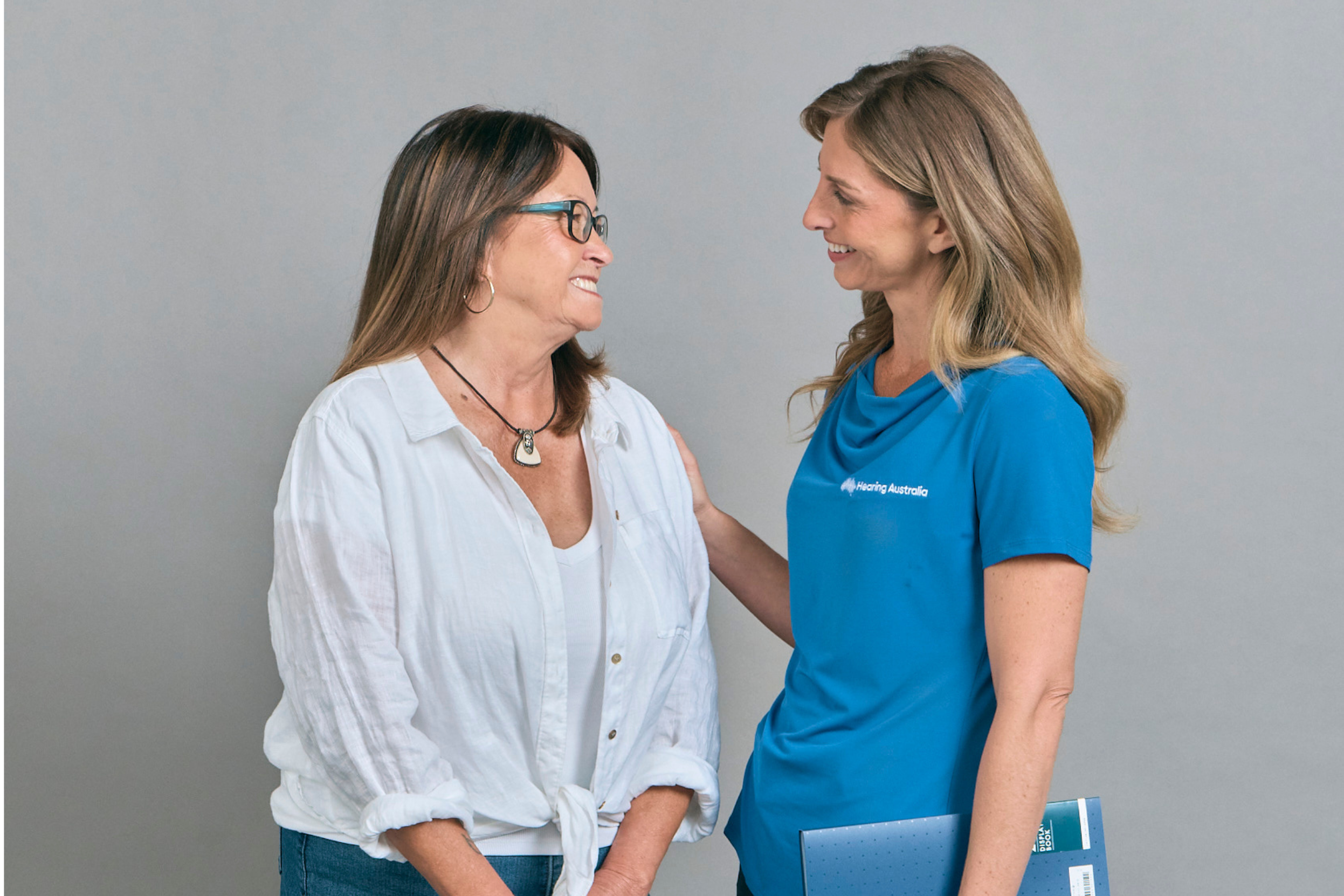a woman smiling at another woman