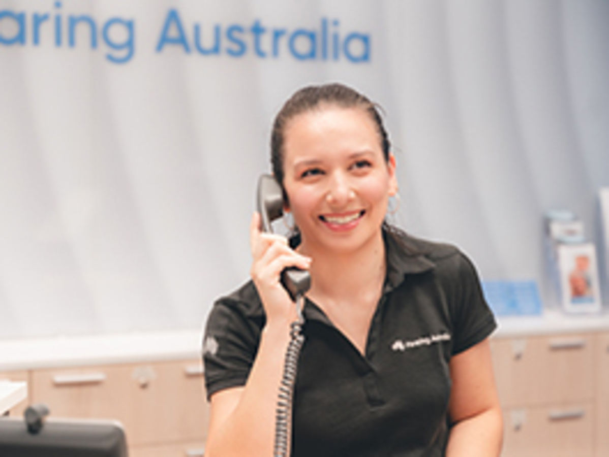a woman holding a phone to her ear