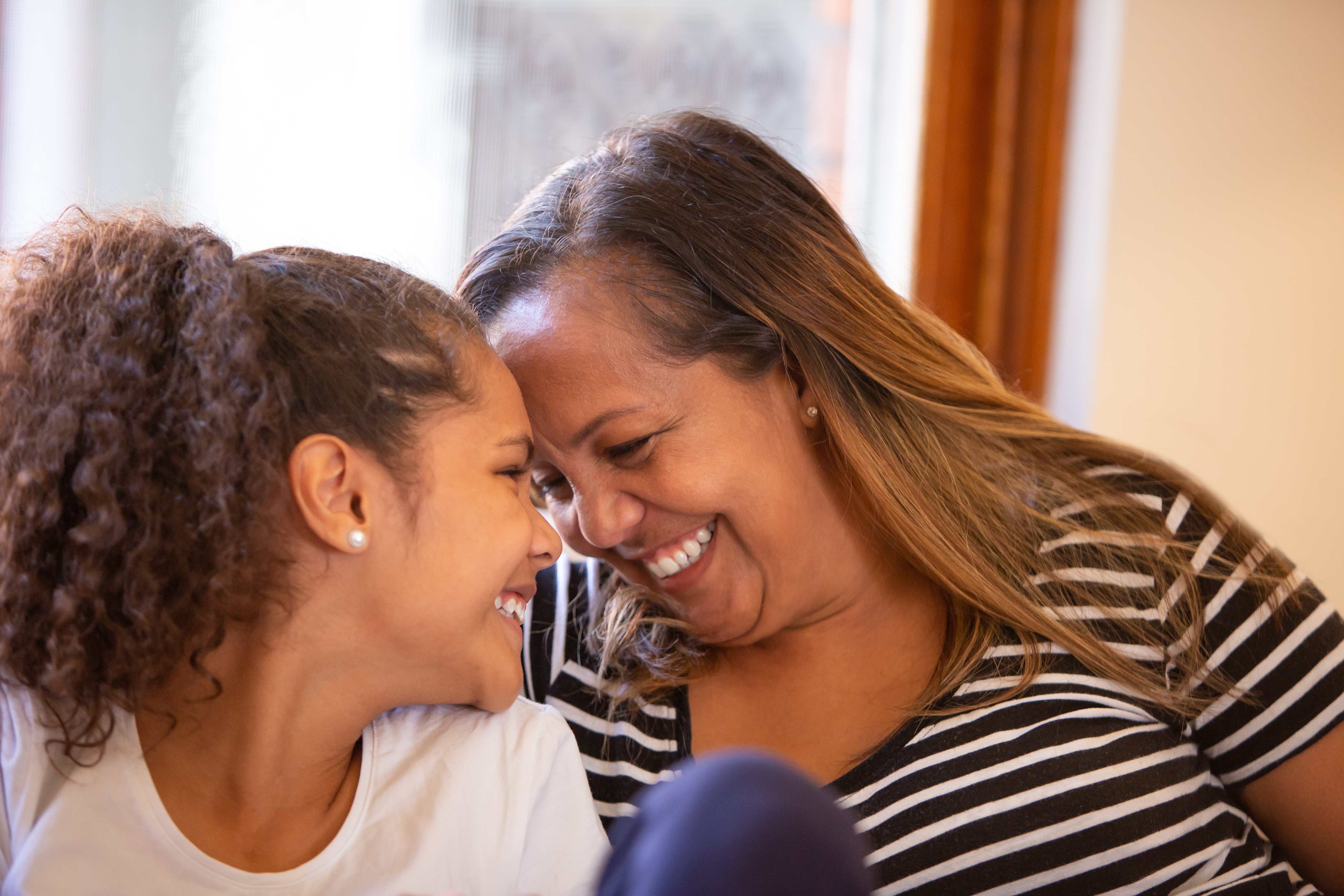 a woman and a girl smiling
GettyImages-959909528