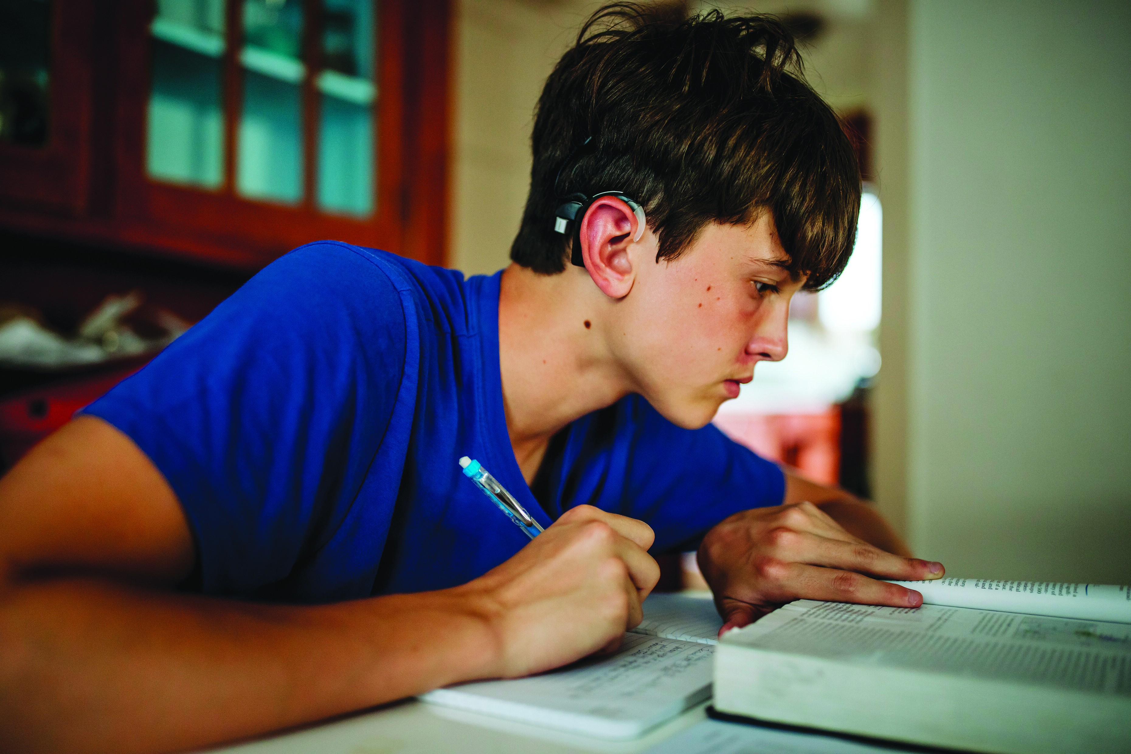 a boy with a hearing aid on his ear