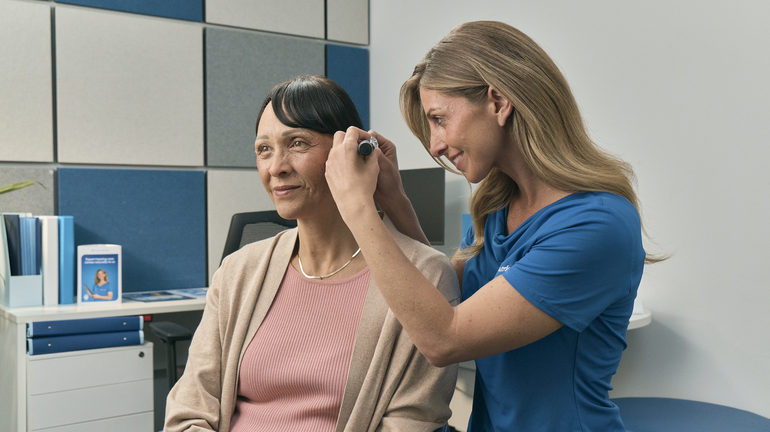 a woman using a device to make a haircut to a woman