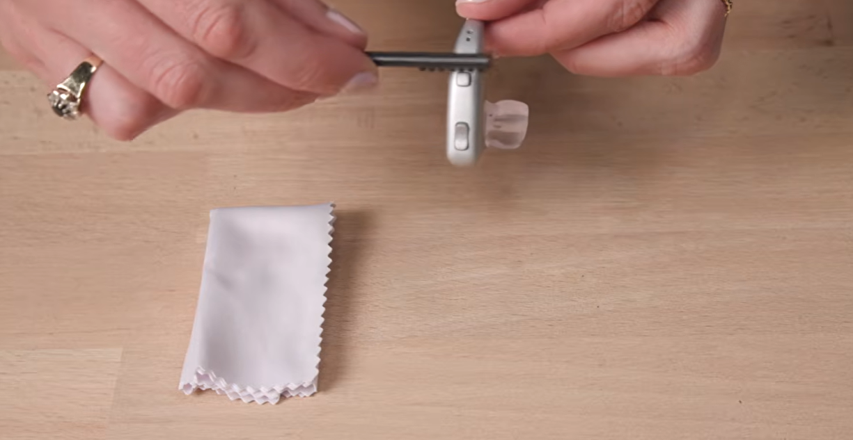 a person holding a small silver device
