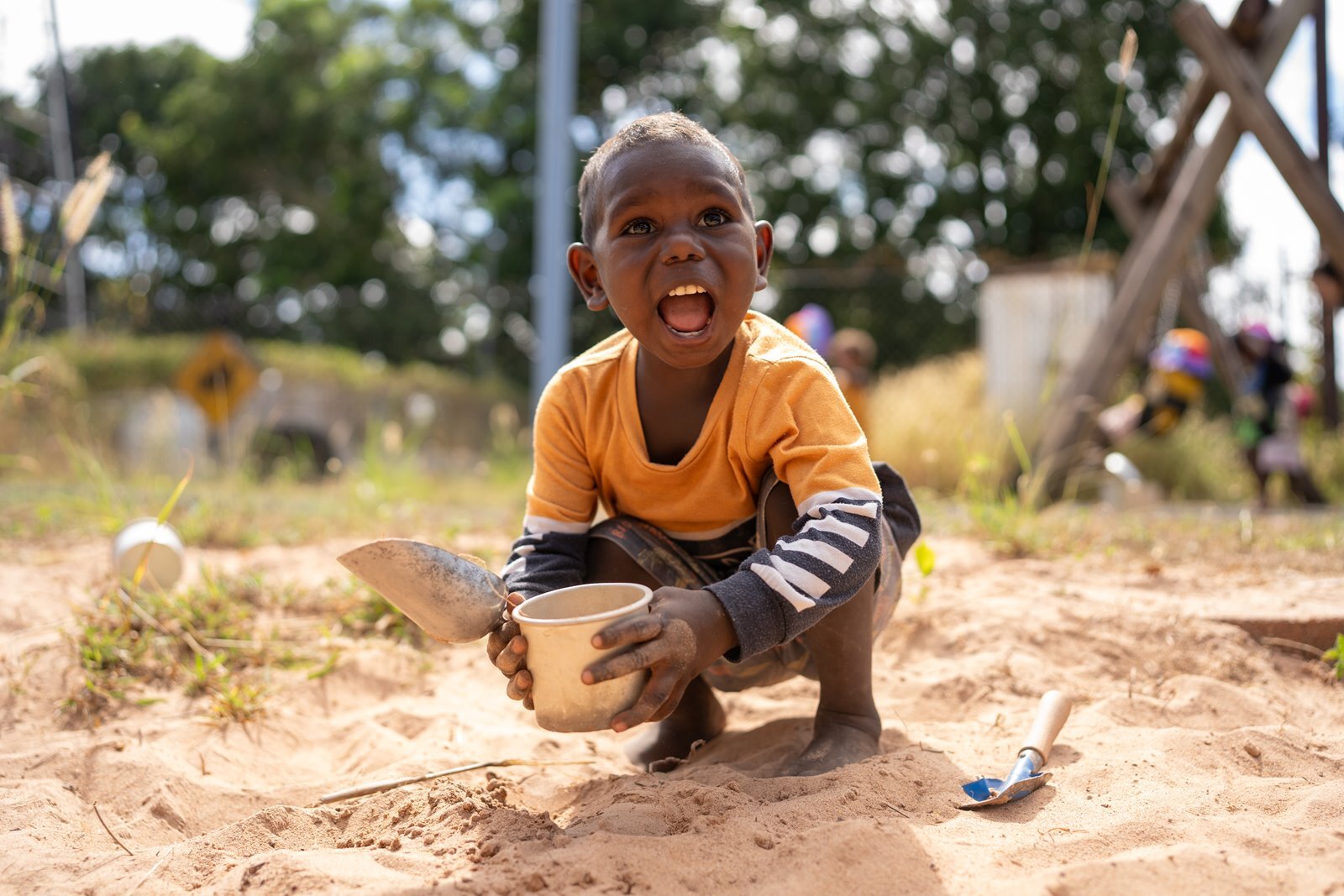 Young boy playing in a sandpit