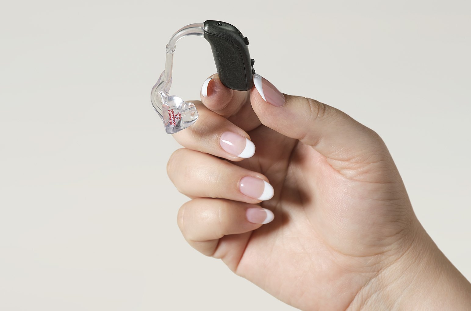 Behind the ear device being held