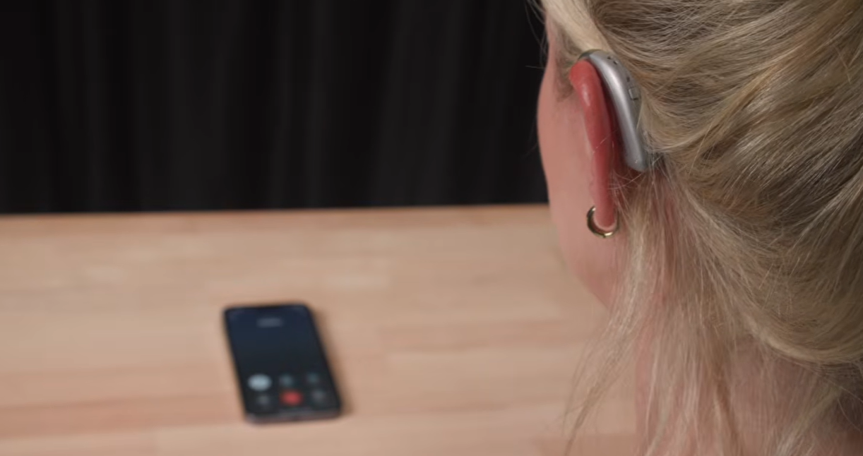 a woman with earpiece and earplug